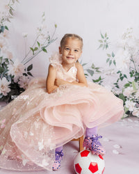 "Detail shot of the one-shoulder ruffle on the Anastasia gown, adding a whimsical and stylish touch."


