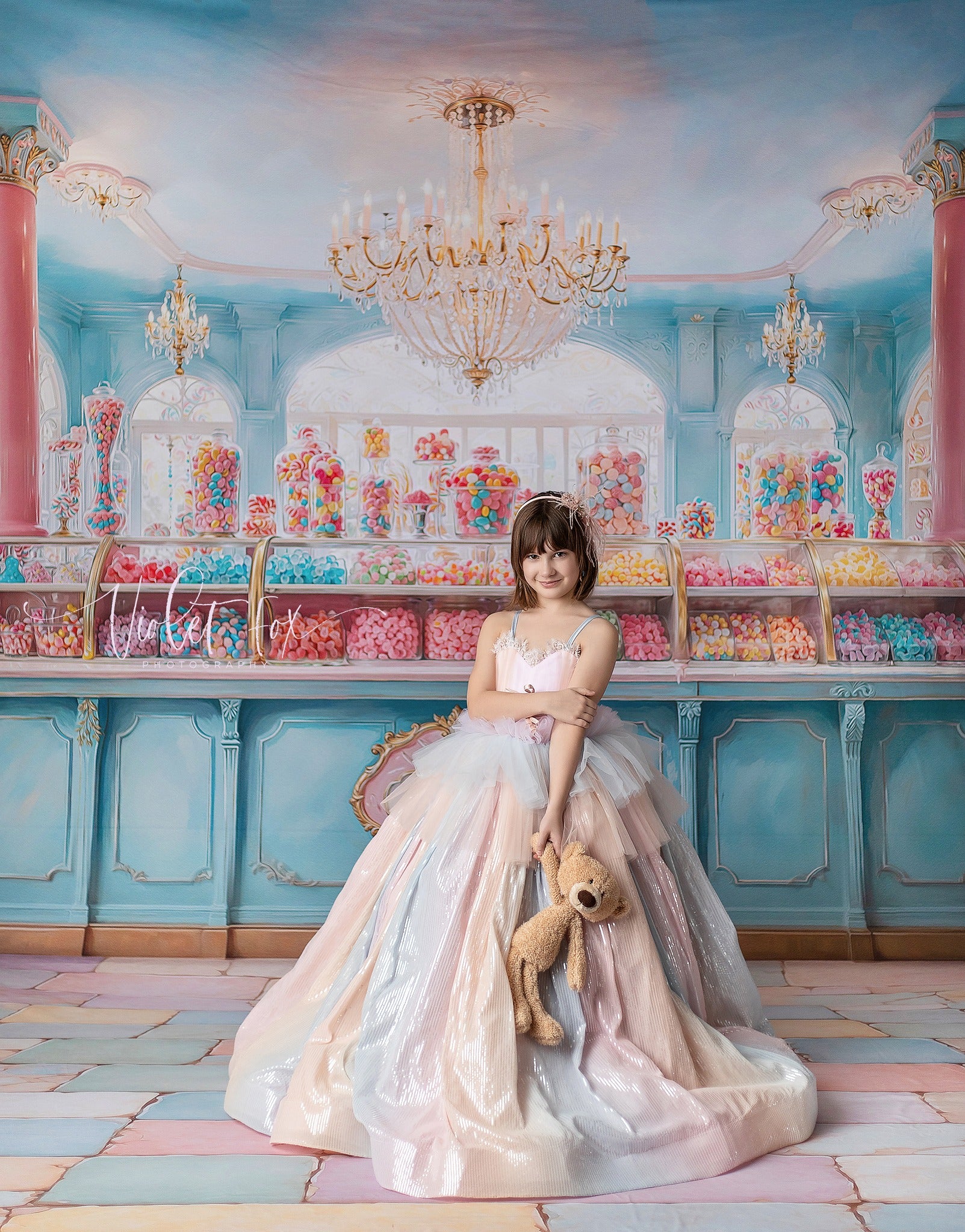 Girl wearing a shimmering pastel ombré gown with tulle layers on a mannequin.
