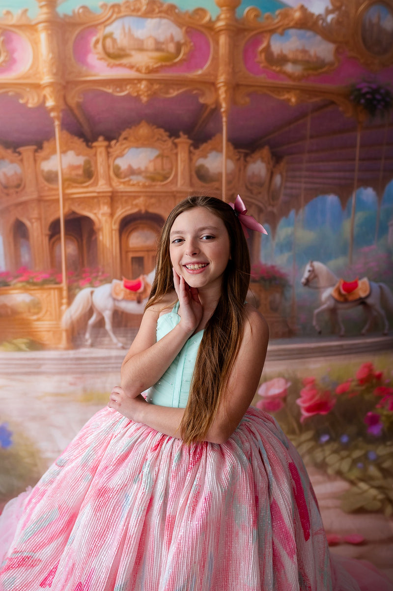 "Close-up of the Cotton Candy Dream gown’s ruffled pastel tulle and intricate floral headpiece, perfect for a whimsical photoshoot."


