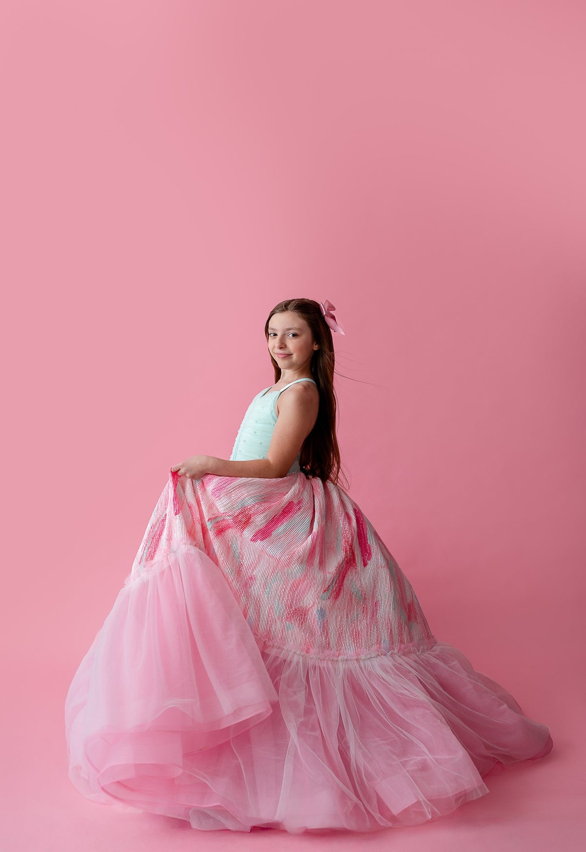 "Soft pastel Cotton Candy Dream gown with layers of airy tulle, paired with a delicate floral headpiece for a dreamy look."

