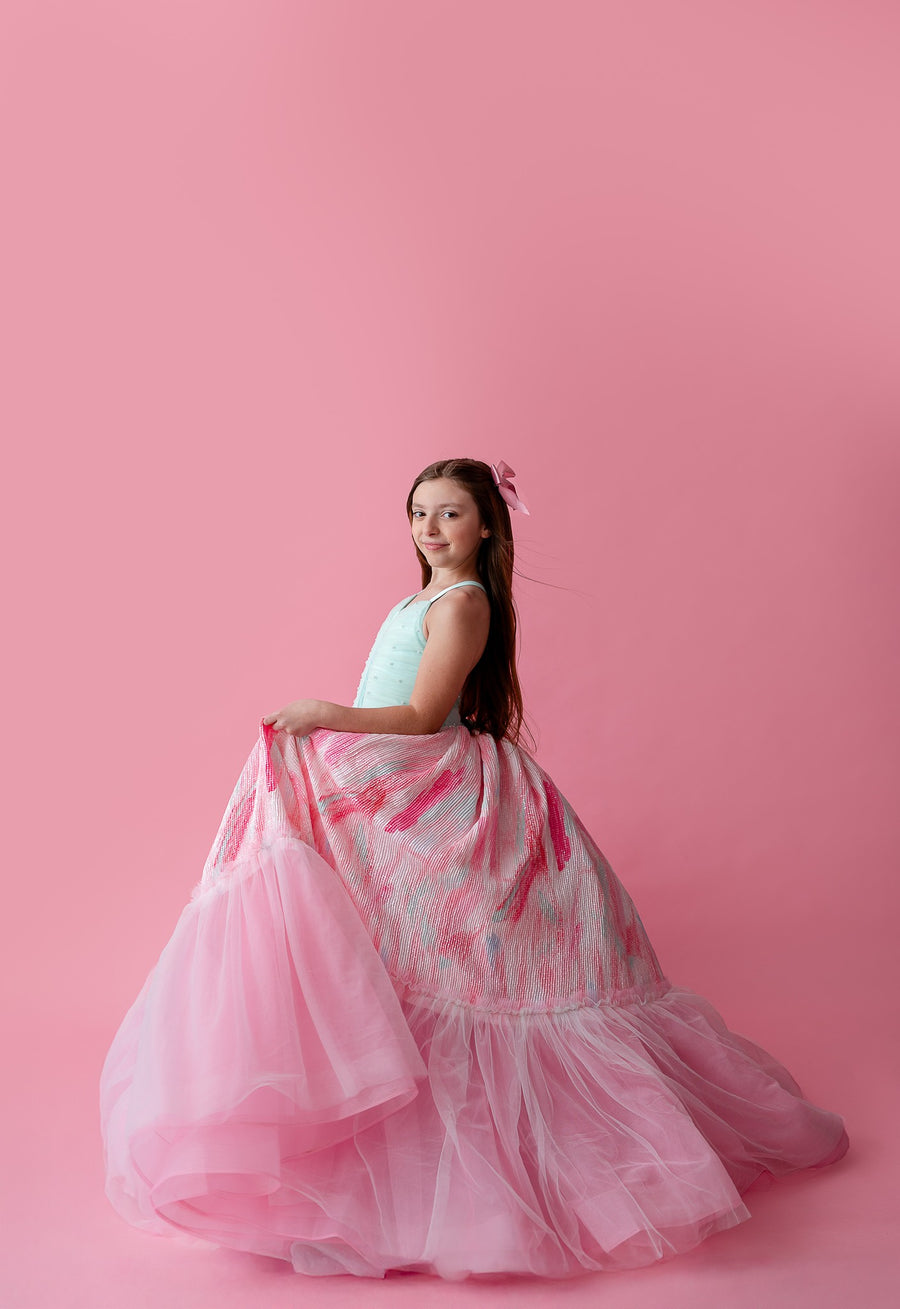 "Soft pastel Cotton Candy Dream gown with layers of airy tulle, paired with a delicate floral headpiece for a dreamy look."

