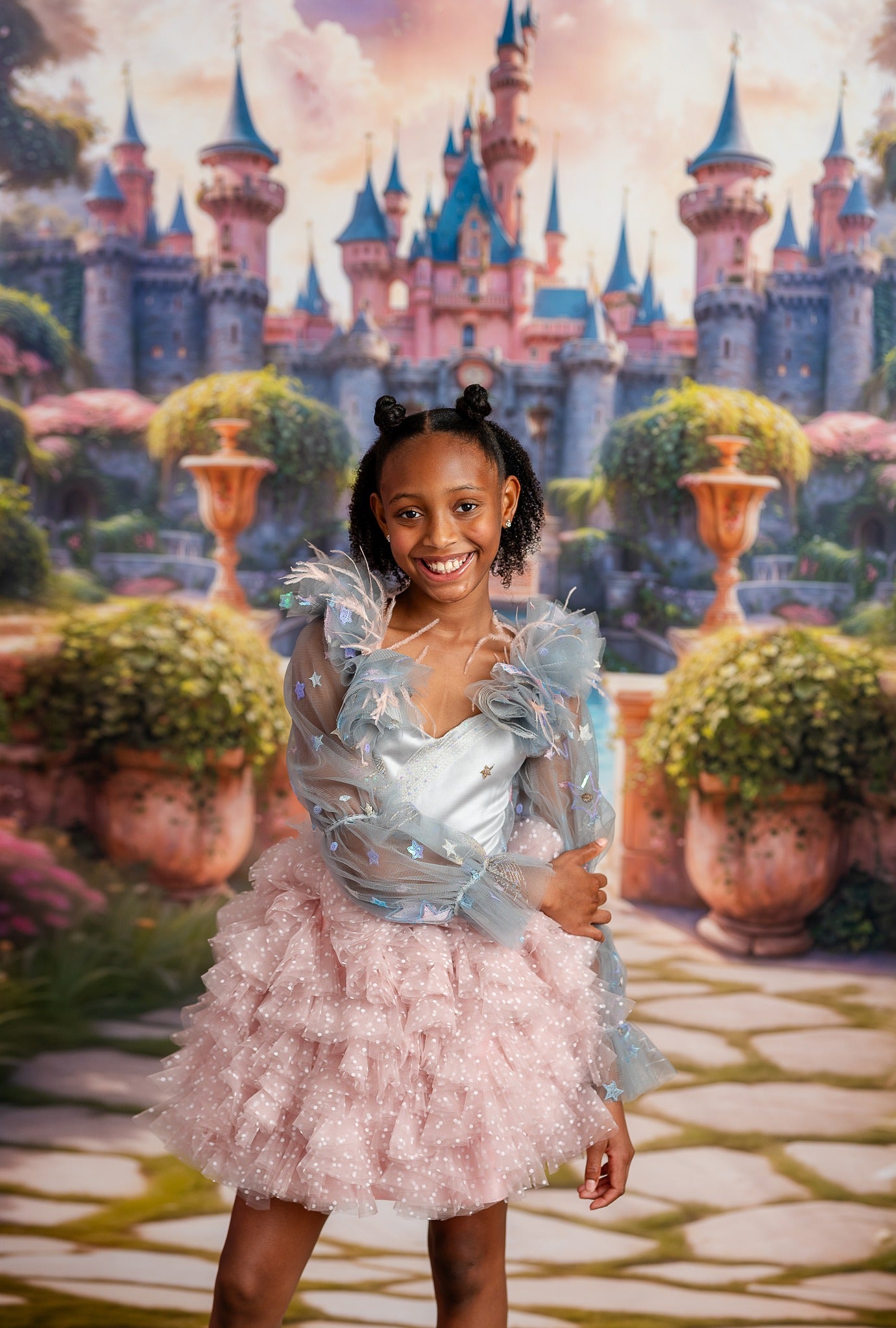 Girl wearing Starlight Princess dress in pink and silver with 3D star details and feathered tulle sleeves.

