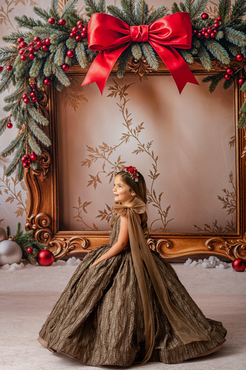 "Young girl wearing a couture gown made of elegant jacquard fabric with oversized removable tulle bows on the shoulders."

