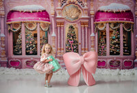 "Close-up of a couture girls’ dress with sparkling silver bow embroidery on velvet fabric, paired with a satin puff sleeve bodice for a whimsical and high-fashion look."

