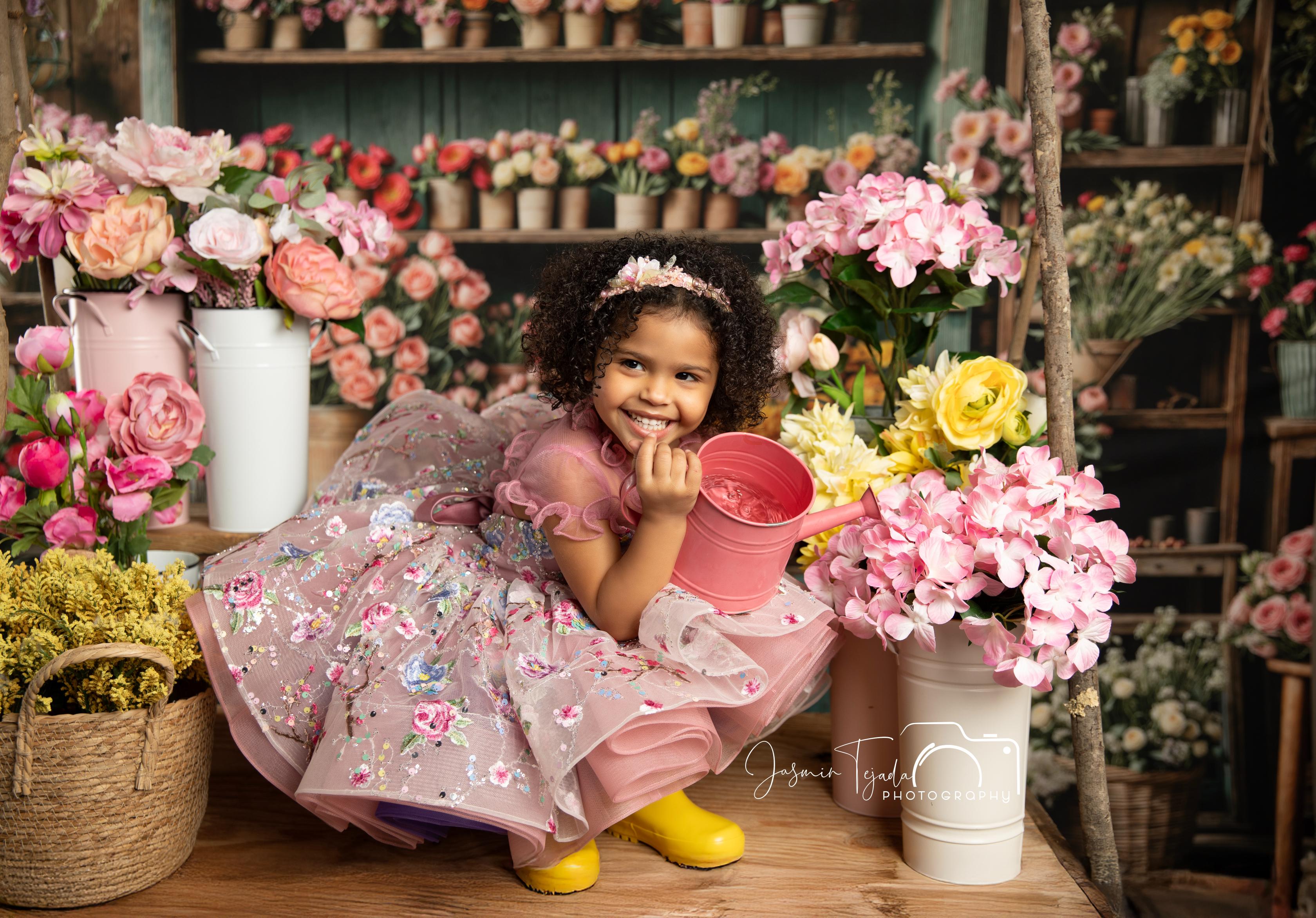 Delicate petals adorn this ethereal gown, blending pastel hues with a flowing silhouette.
