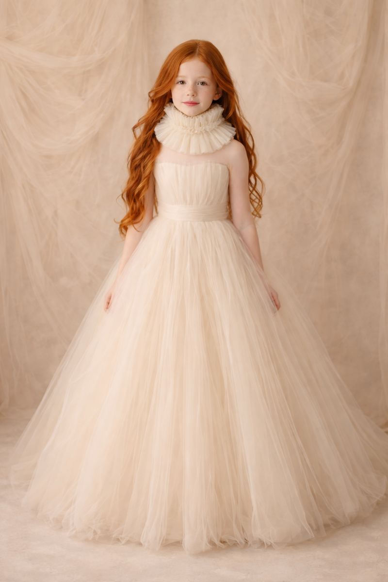 Young girl in a beige dress with a textured backdrop