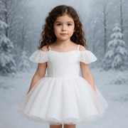 Young girl in a white dress standing in a snowy forest