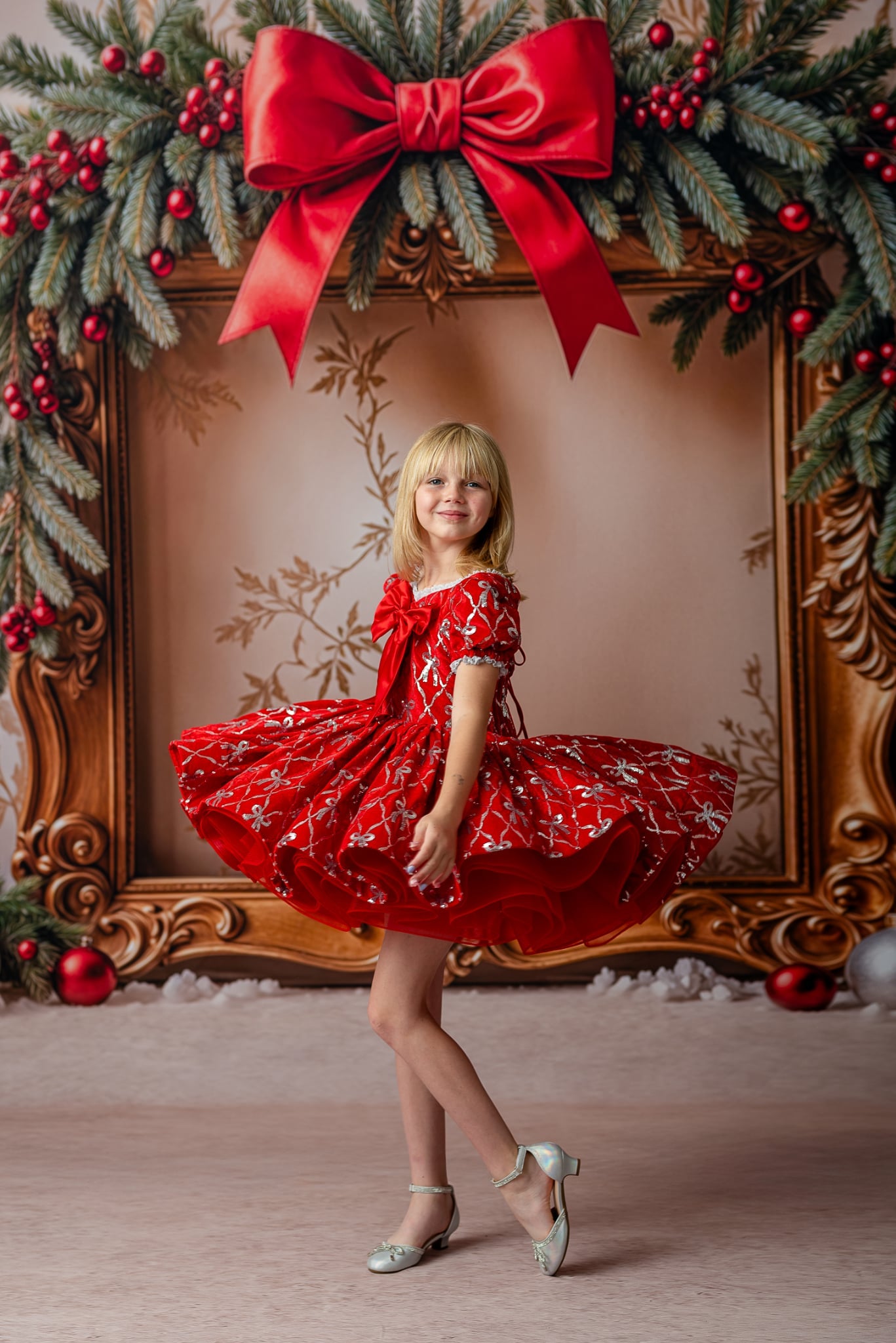 Festive styled session with model standing, red velvet skirt -wearing cape with hood up for magical storytelling look.


