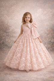 Young girl in a pink floral dress with a large bow on a textured background
