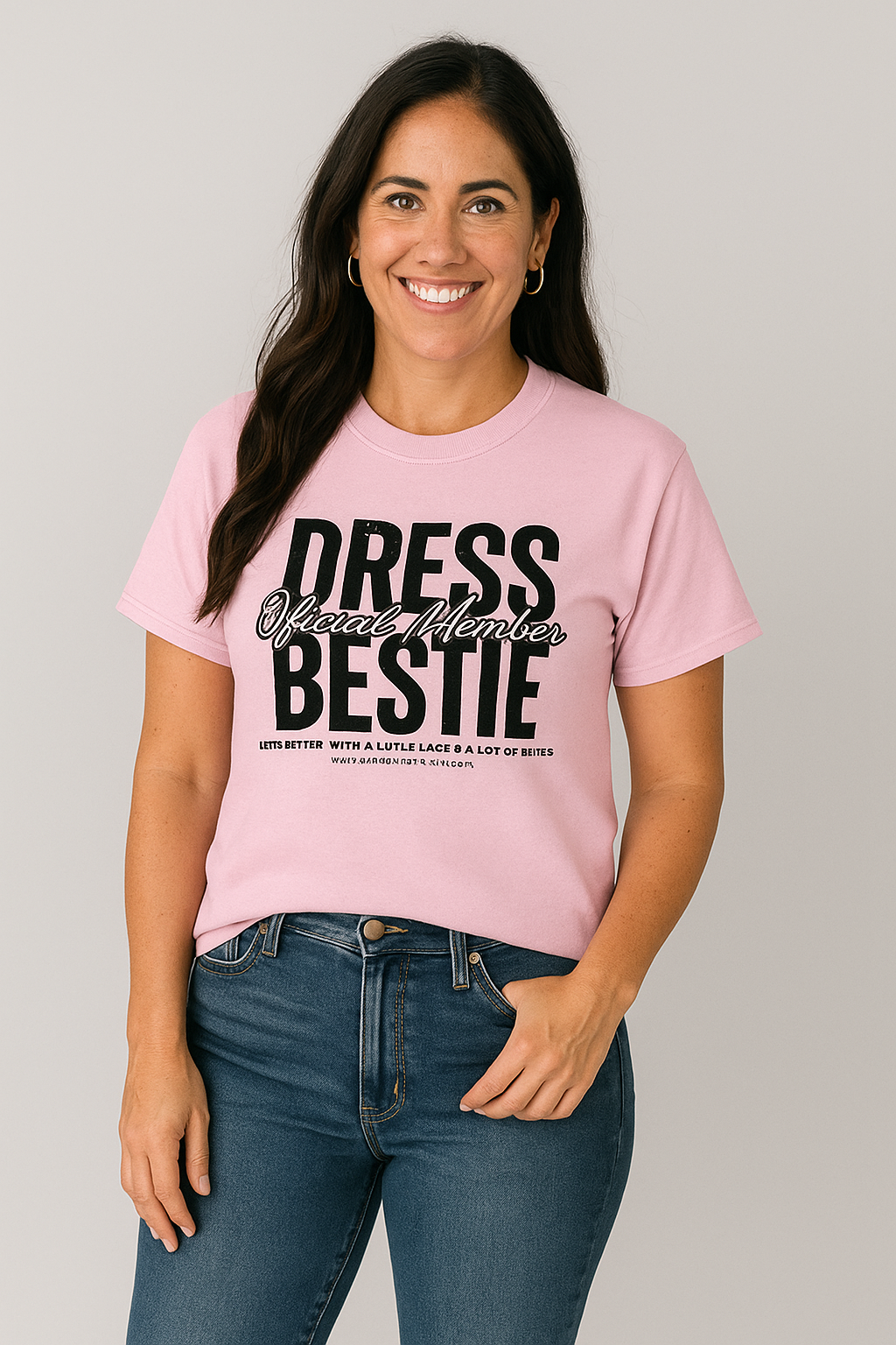 Woman wearing a pink t-shirt with 'Dress Bestie' text on a gray background