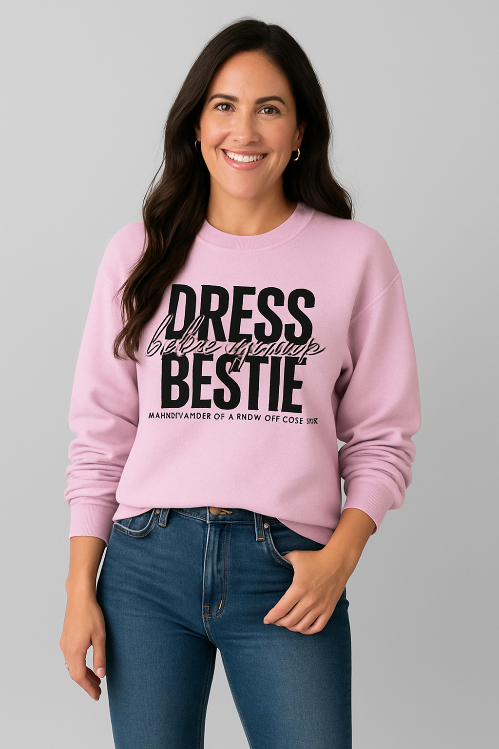 Woman wearing a pink sweatshirt with text, standing against a gray background