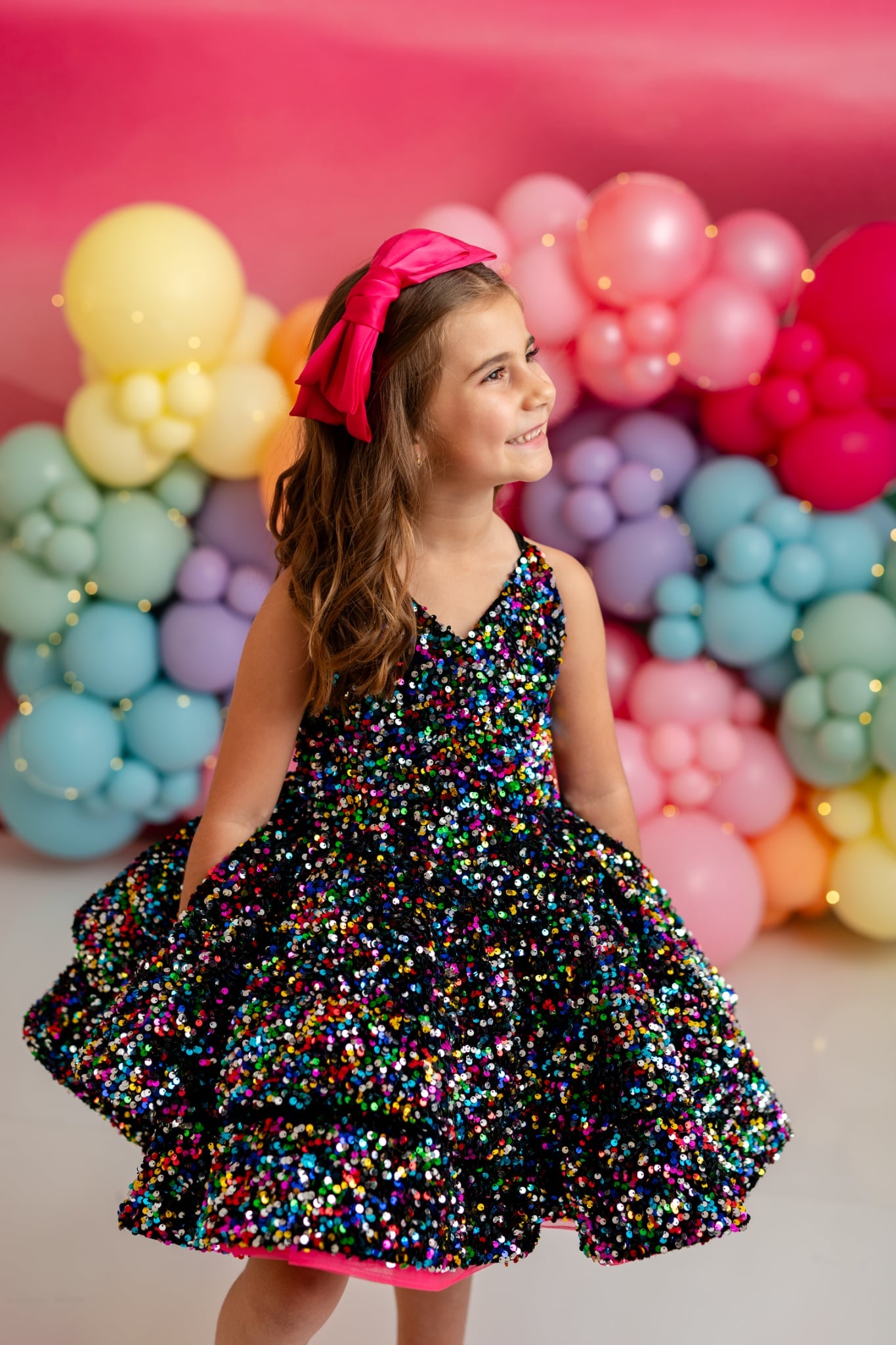 Model wearing Bentley and Lace Prism Sparkle Dress in black and sparkle tones – short petal length couture style