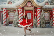 Girl wearing Mrs. Claus & Co. holiday dress with red cape and detachable bow

