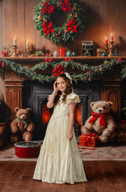 Child wearing Clara’s Dream ivory floor-length gown with detachable bow for Nutcracker photography rental