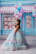 Side profile of a girl wearing the gown, revealing the rainbow detailing and hemline bows, captured by Kayla Rinehart Photography.

