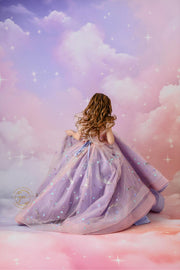 "A magical portrait of a girl in a flowing pink and lavender dress, perfect for a fantasy-themed photoshoot."

