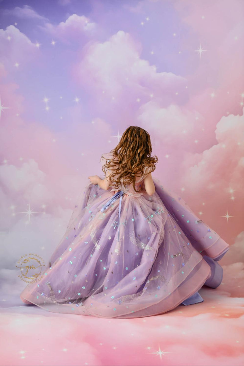 "A magical portrait of a girl in a flowing pink and lavender dress, perfect for a fantasy-themed photoshoot."

