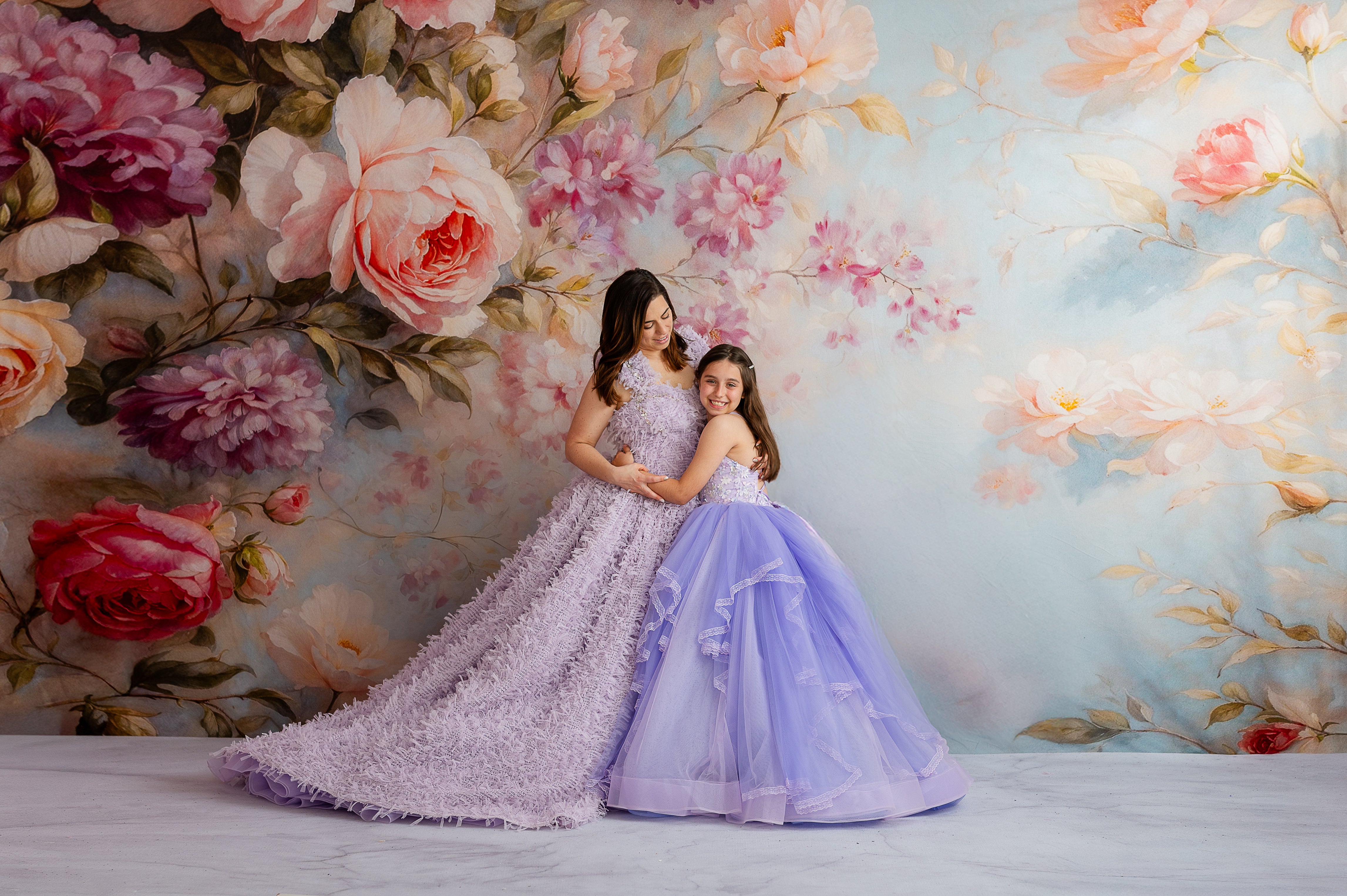Full-length shot showing the gown’s elegant floor-length silhouette and layered flow.


