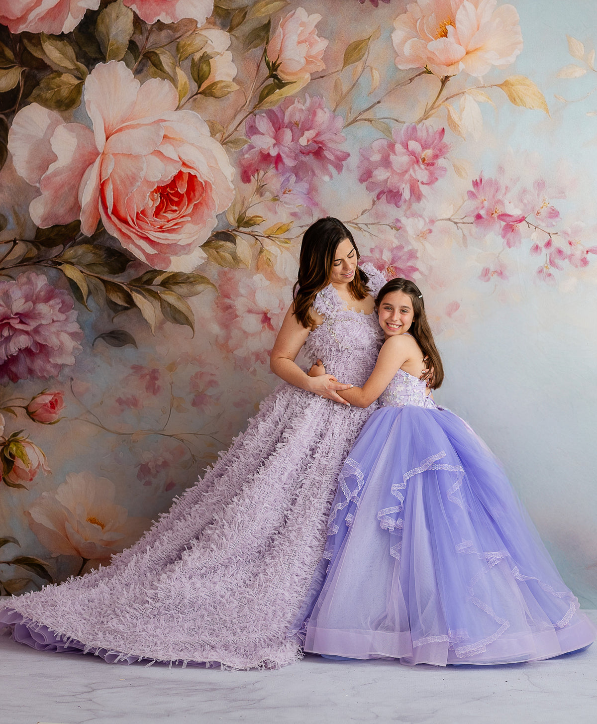 Front view of Aurelia’s Dream Lavender gown with flowing ruffled fabric and rhinestone neckline detailing.

