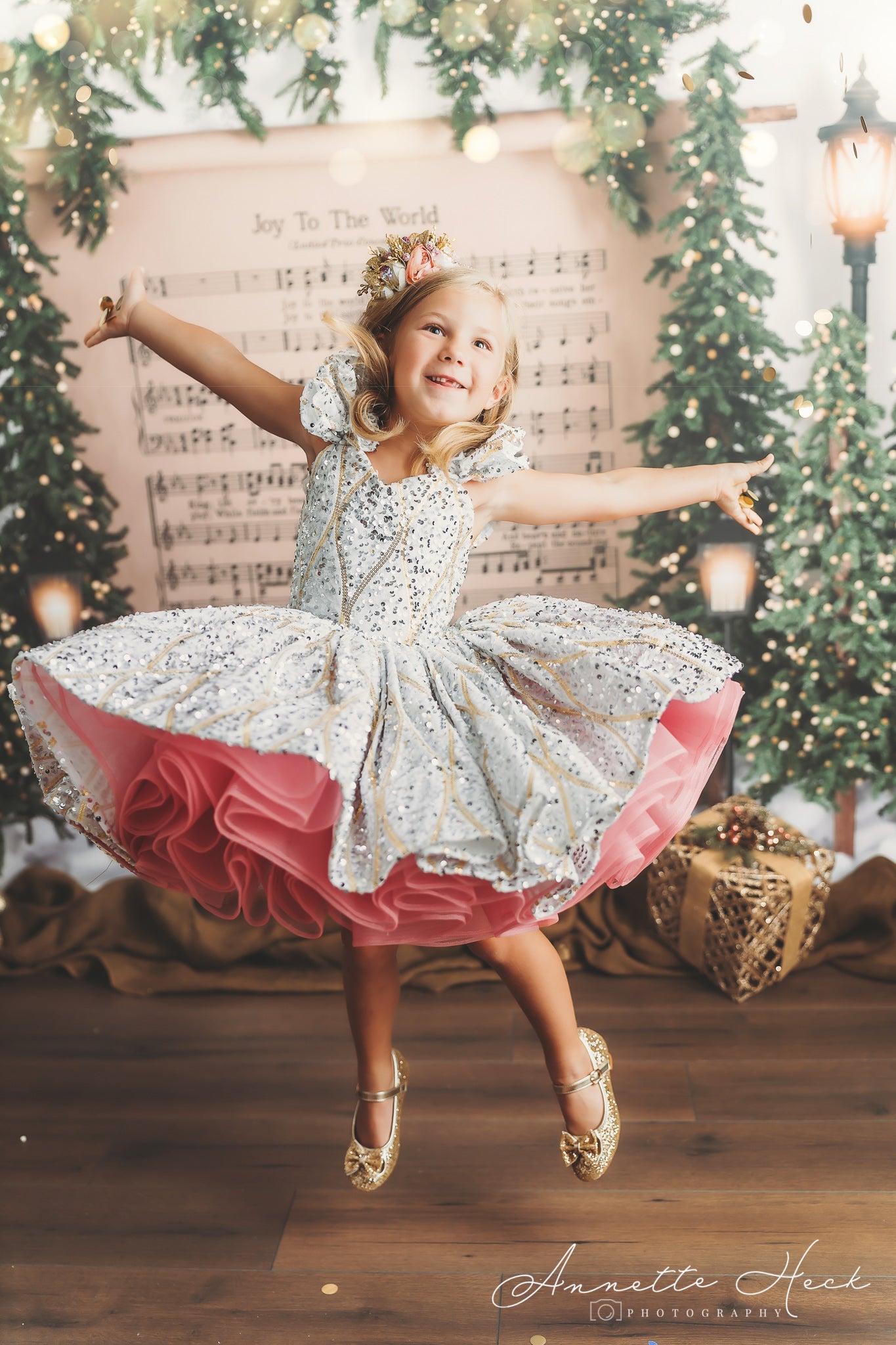 Blonde girl spinning in a white dress with gold accents and a pink ruffled underskirt, creating a dynamic motion effect.