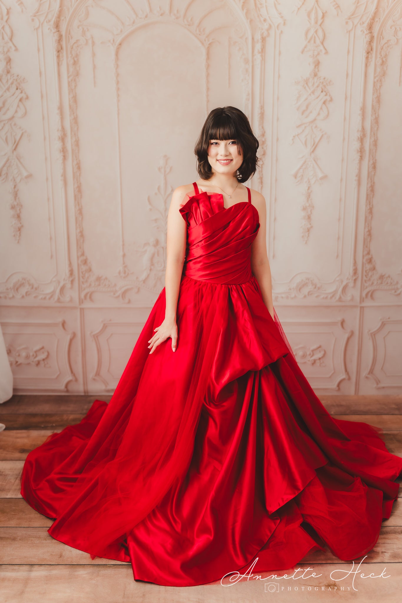 Sophisticated red satin dress with a structured bodice and flowing skirt.