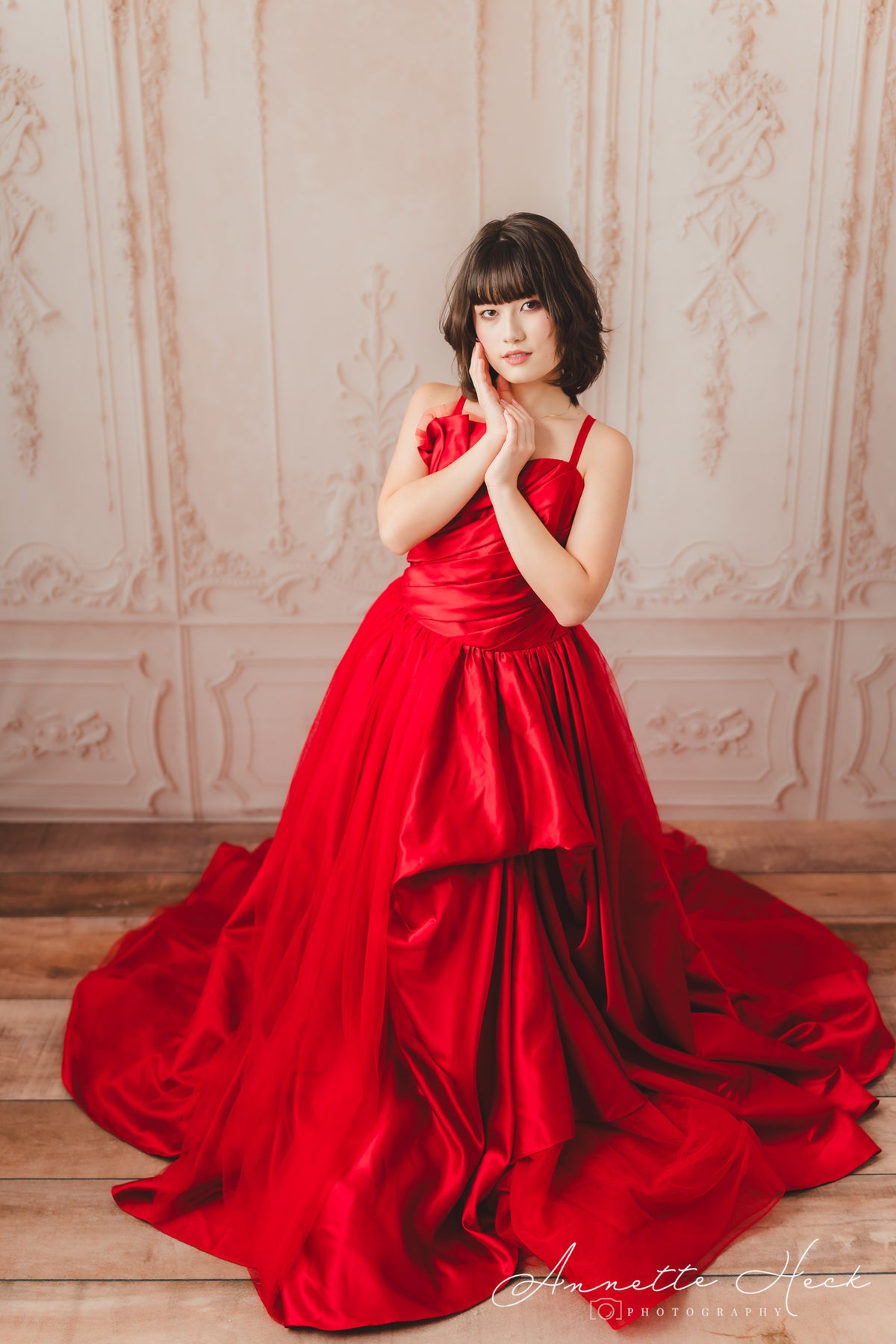 Chic red satin gown adorned with a stylish belt, perfect for formal occasions.