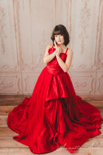Chic red satin gown adorned with a stylish belt, perfect for formal occasions.