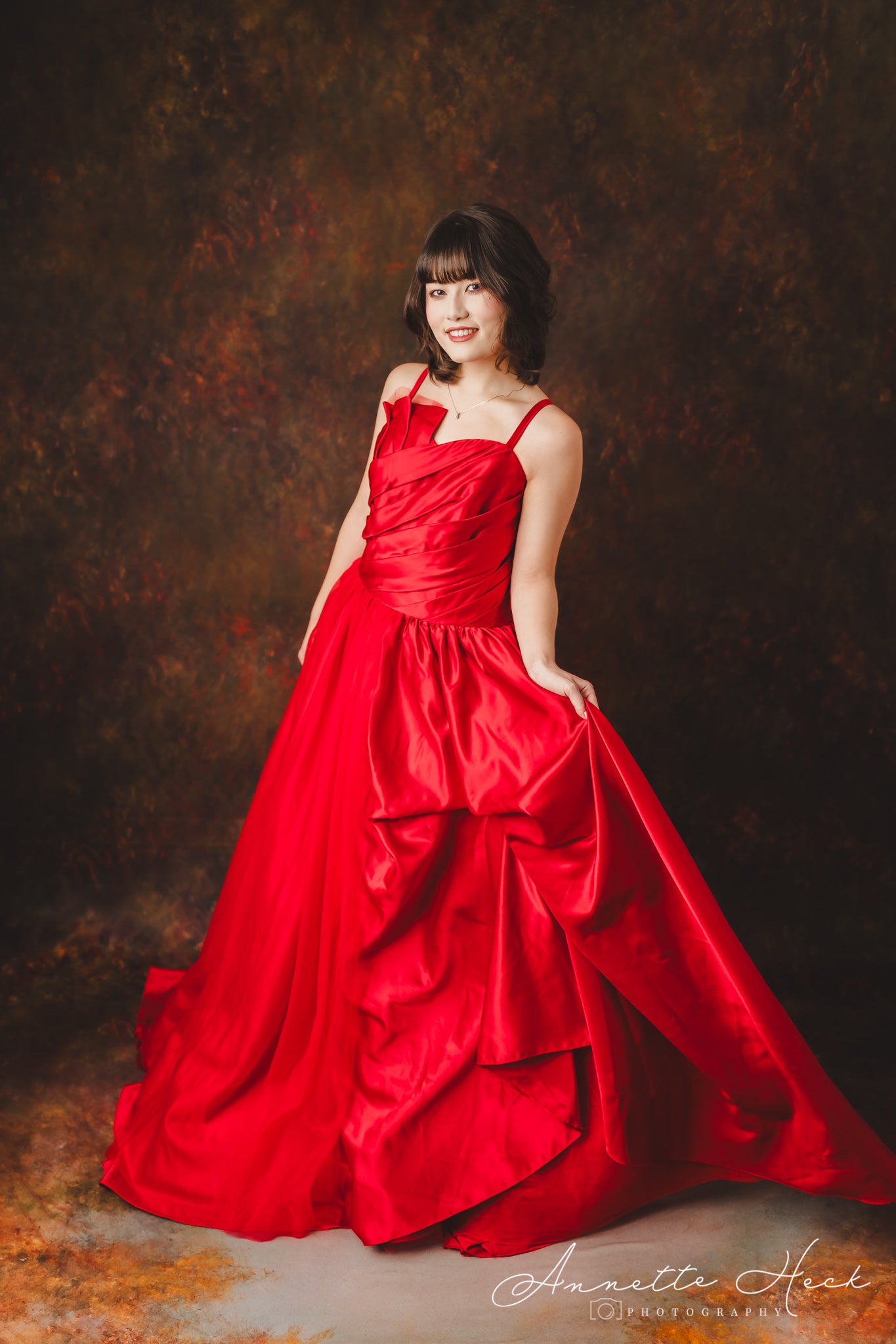 Glamorous red satin evening gown embellished with shimmering sequins.