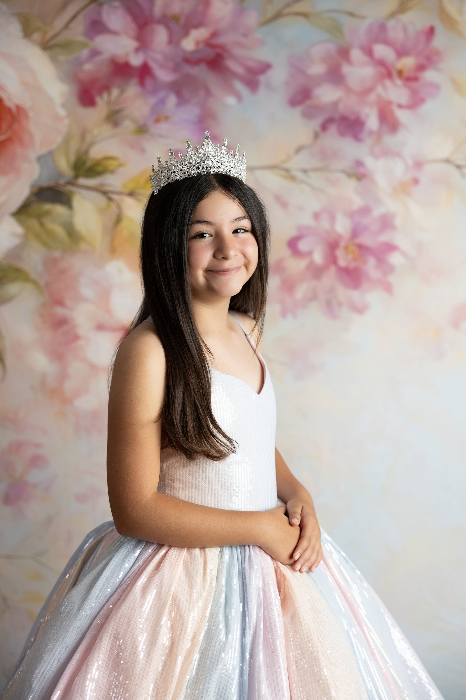 Girl posing in the Aurora Gleam Gown with detachable tulle sleeves floating gently


