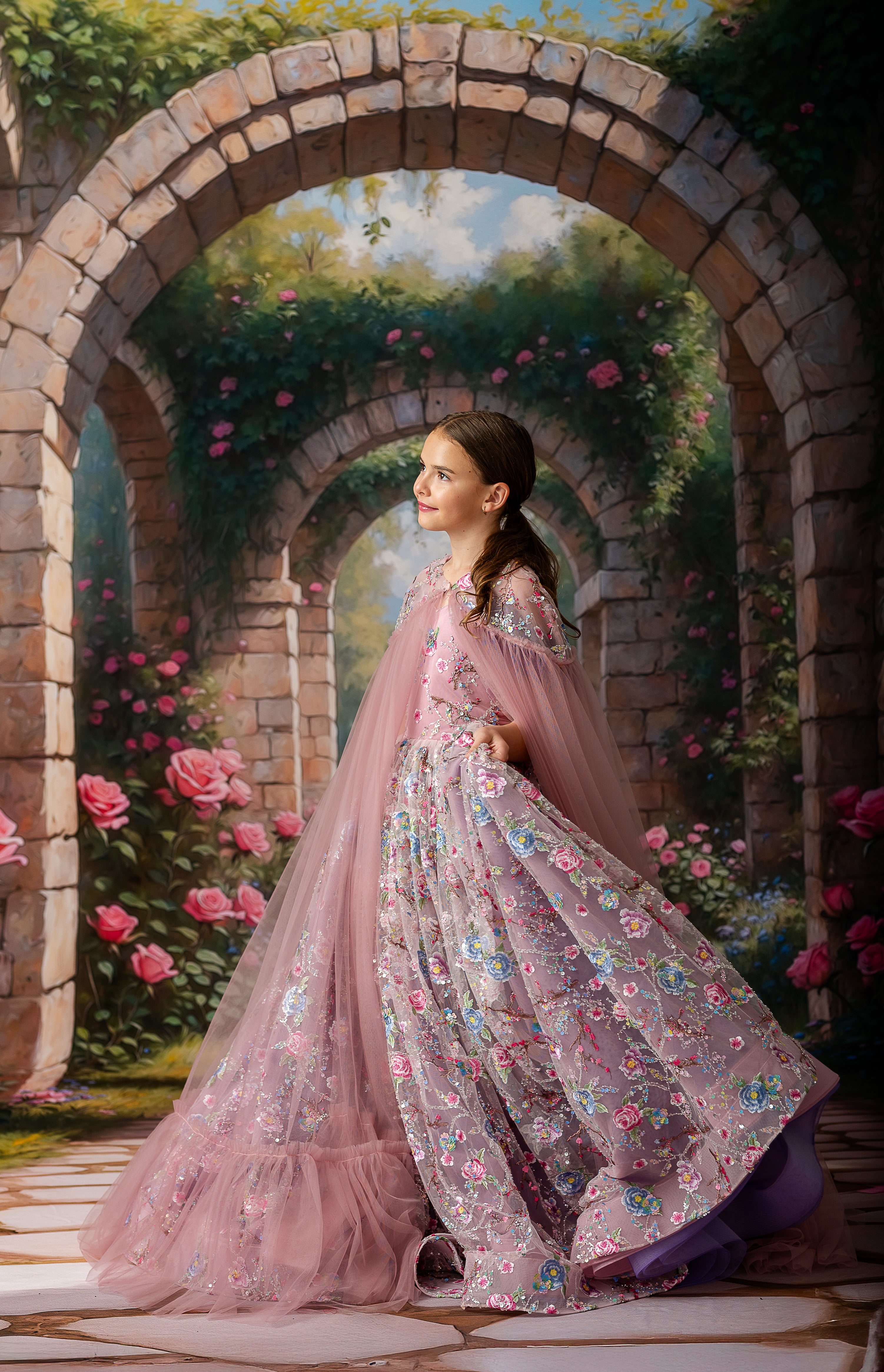 Luxury girls' gown featuring floral embroidery and flowing removable cape

