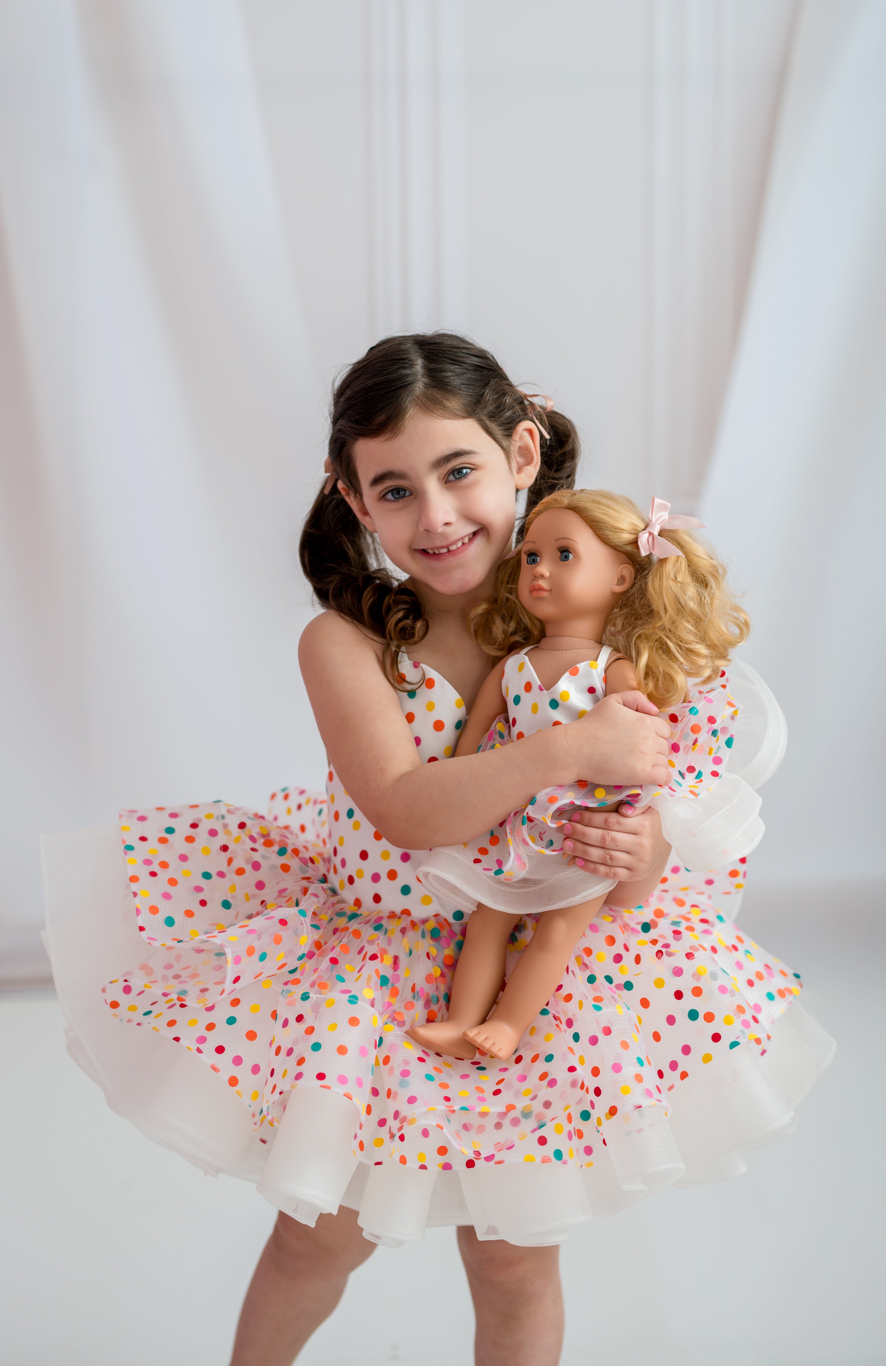 High-end children’s couture dress photographed on mannequin with gold details