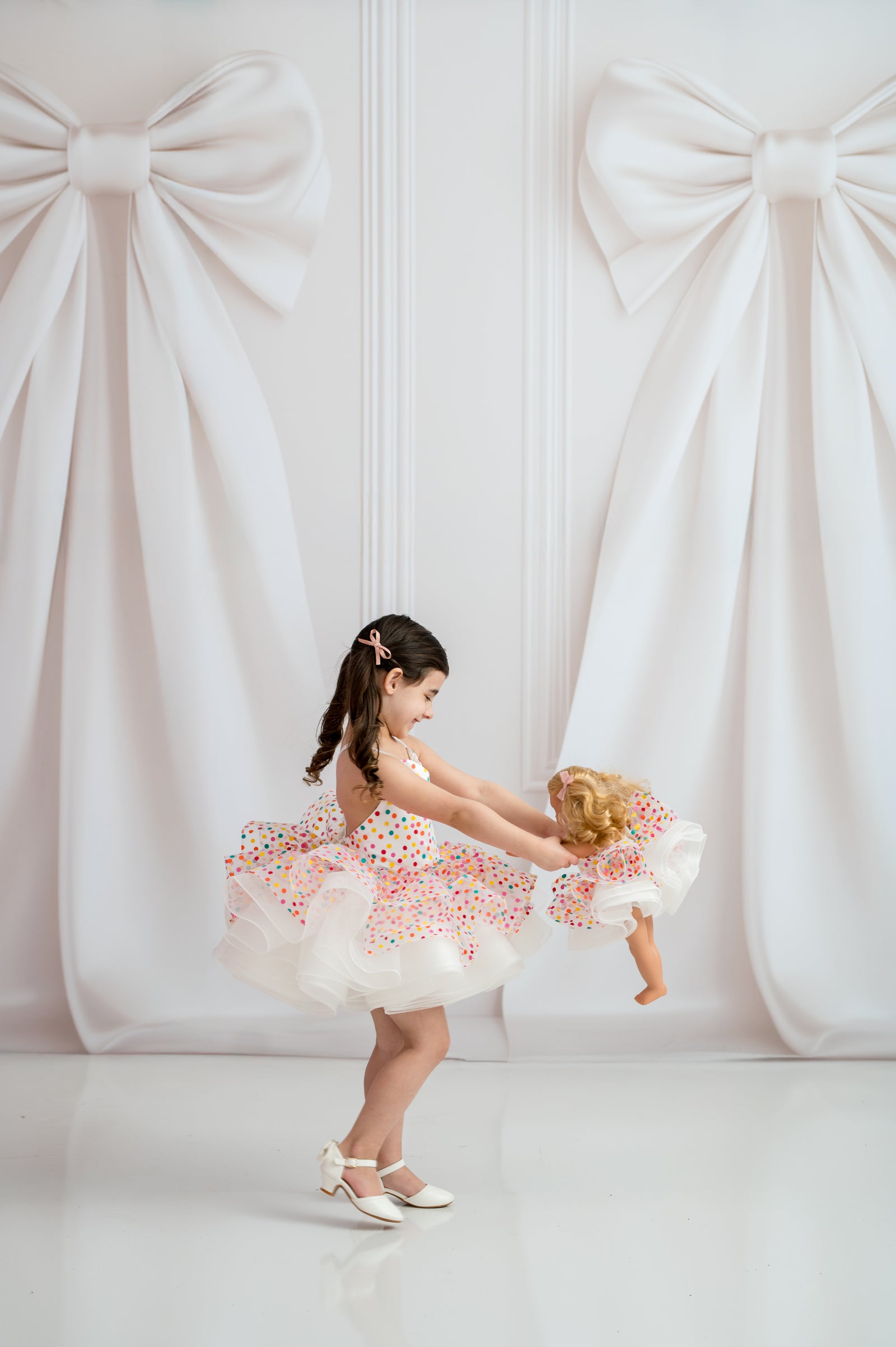 Sweetheart neckline girls dress with white satin straps on studio mannequin