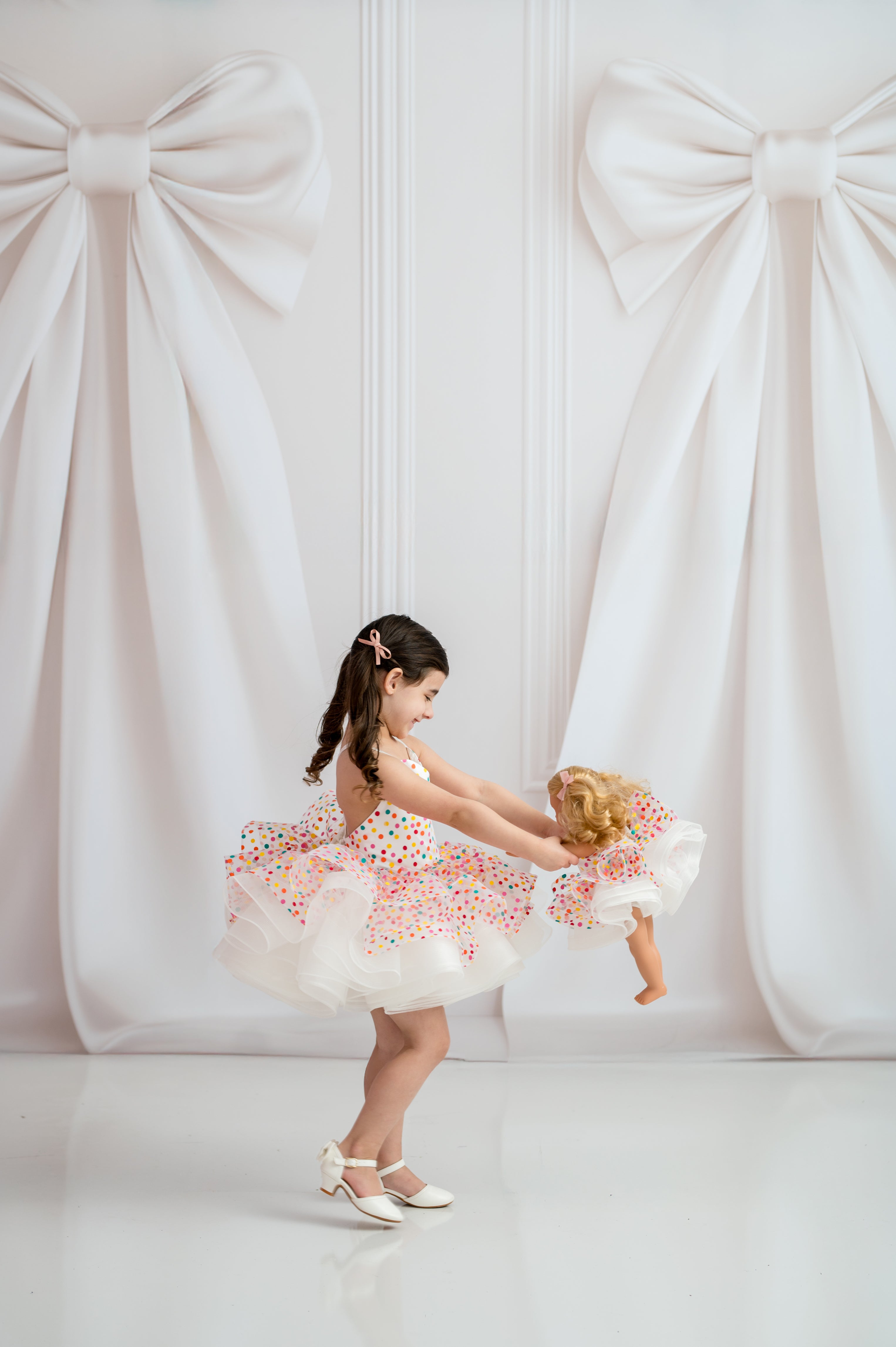 Sweetheart neckline girls dress with white satin straps on studio mannequin