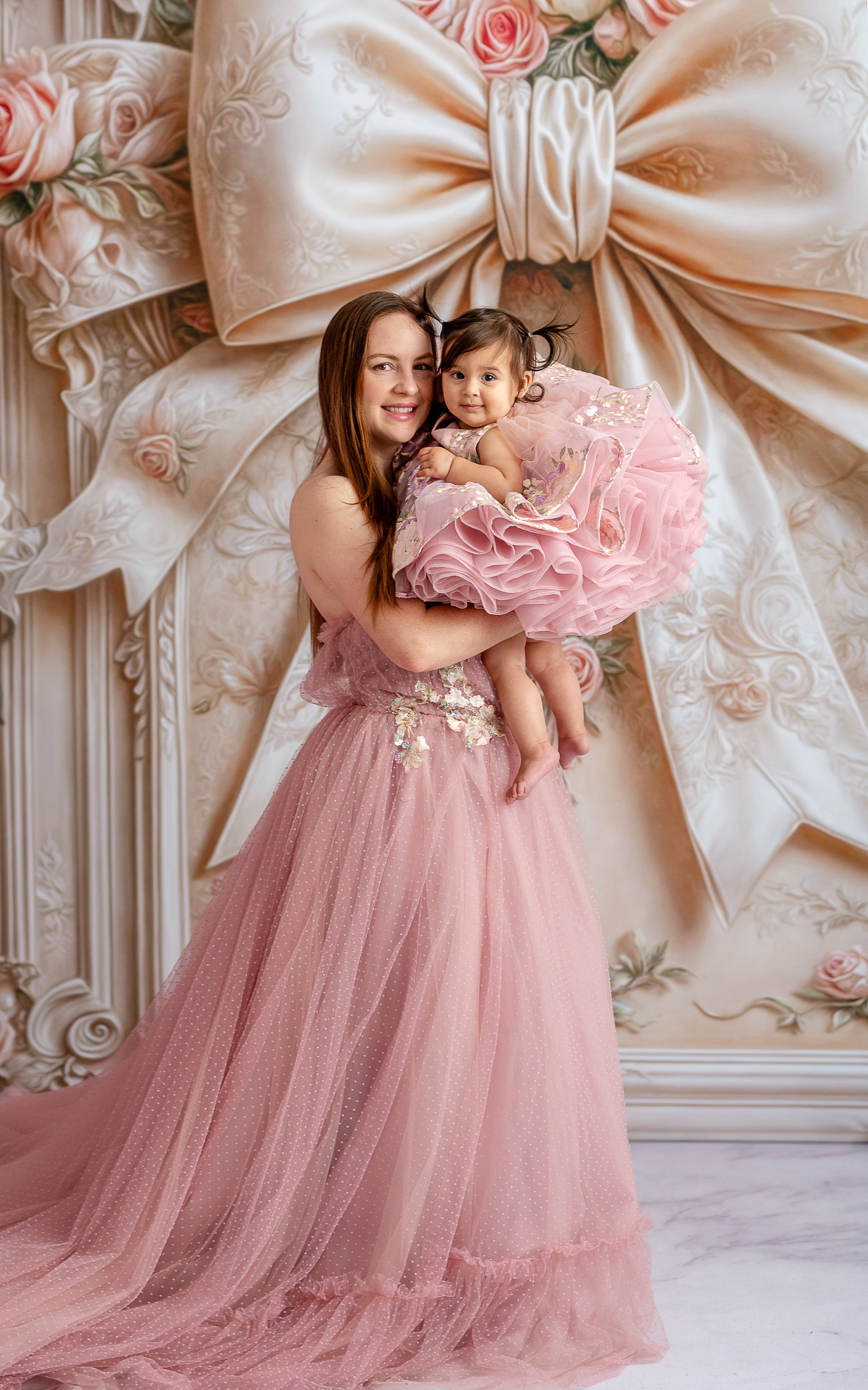 Matching mother and child gowns with floral embellishments
