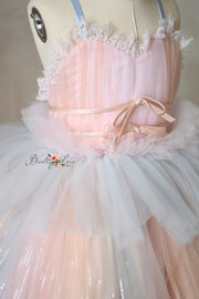 Formal gown with adjustable shoulder ties and a flowing ombré skirt.
