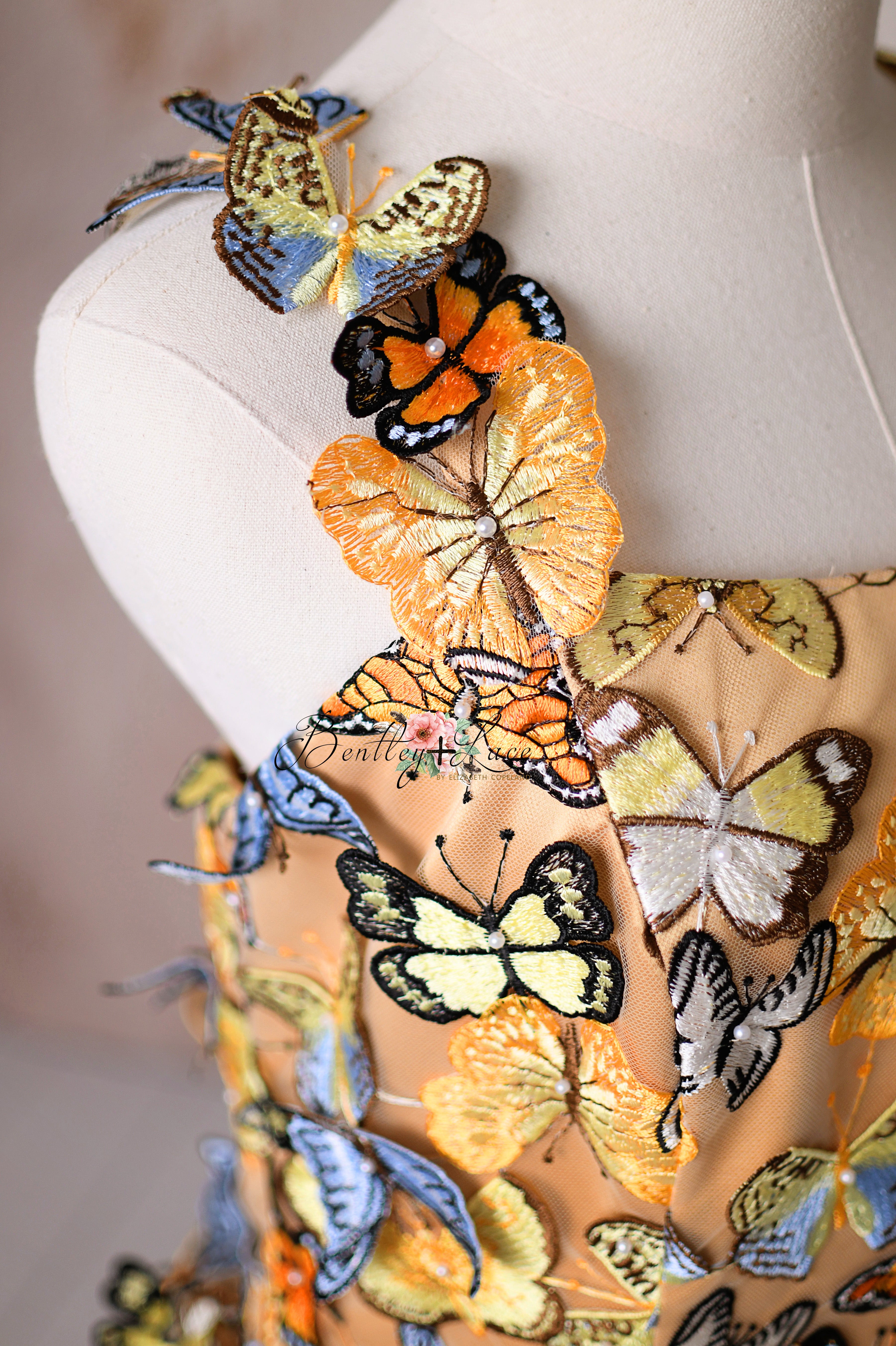 Whimsical butterfly-inspired fashion with a golden top and breezy tiered tulle below.
