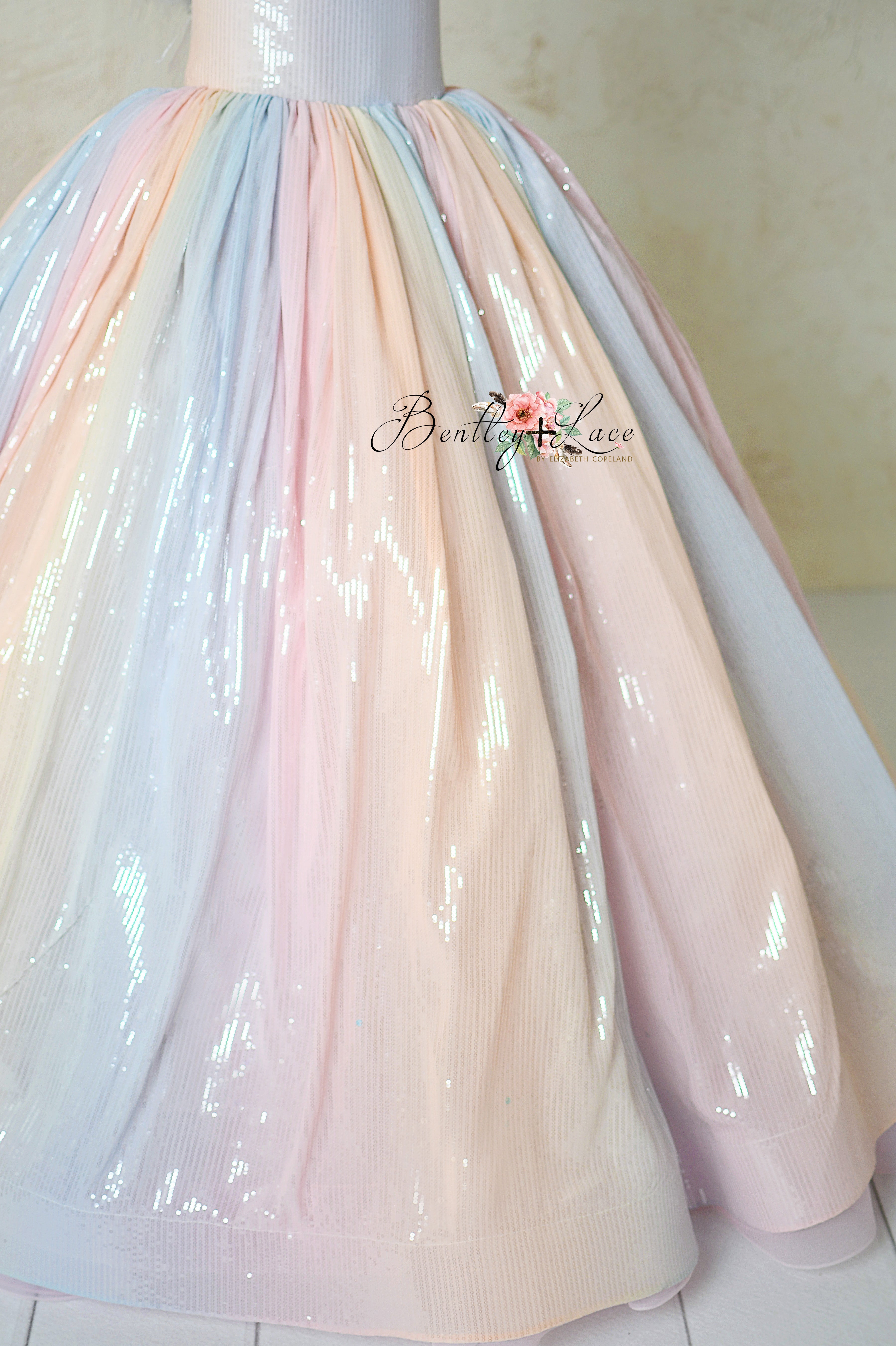 Soft, pastel ombré tulle skirt of Aurora Gleam gown with added volume from built-in crinoline.
