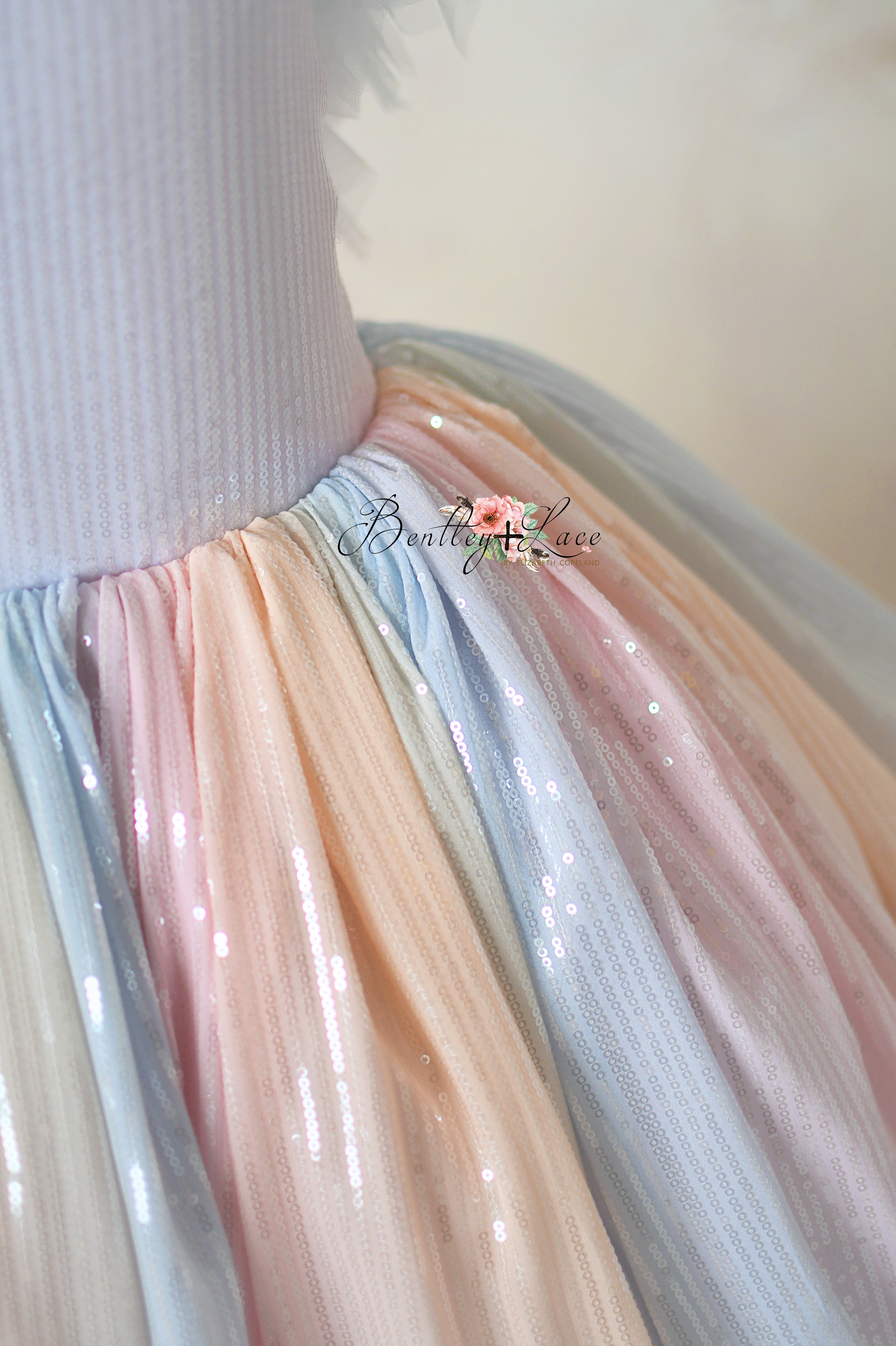 Detailed view of the detachable tulle sleeves on the Aurora Gleam gown.
