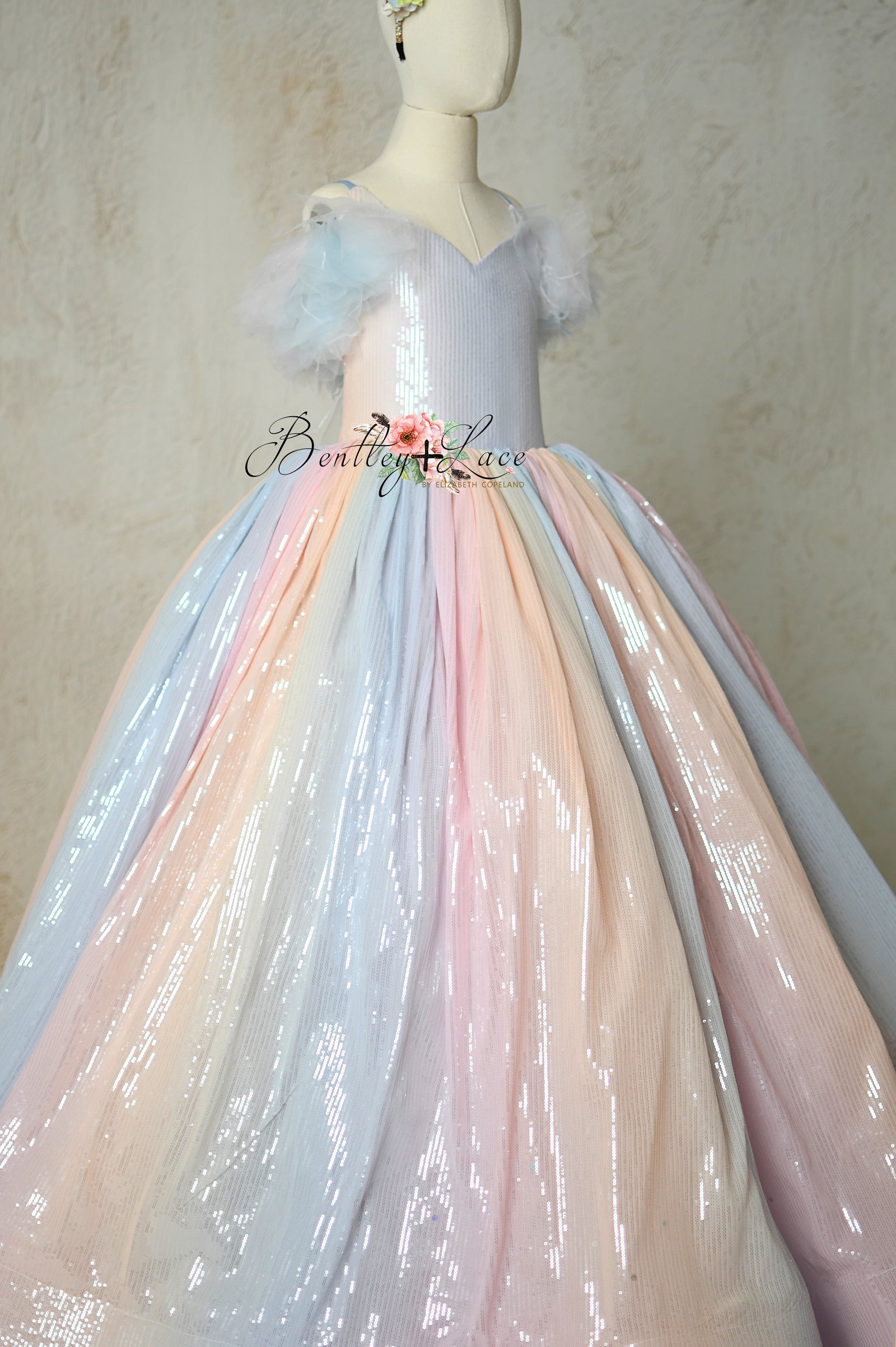Soft pastel ombré fabric and delicate tulle layers on the skirt of Aurora Gleam gown.
