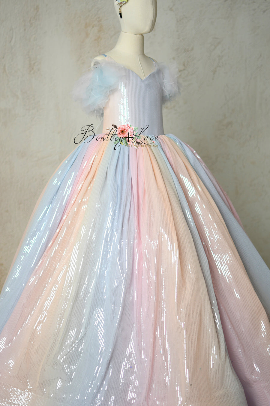 Soft pastel ombré fabric and delicate tulle layers on the skirt of Aurora Gleam gown.
