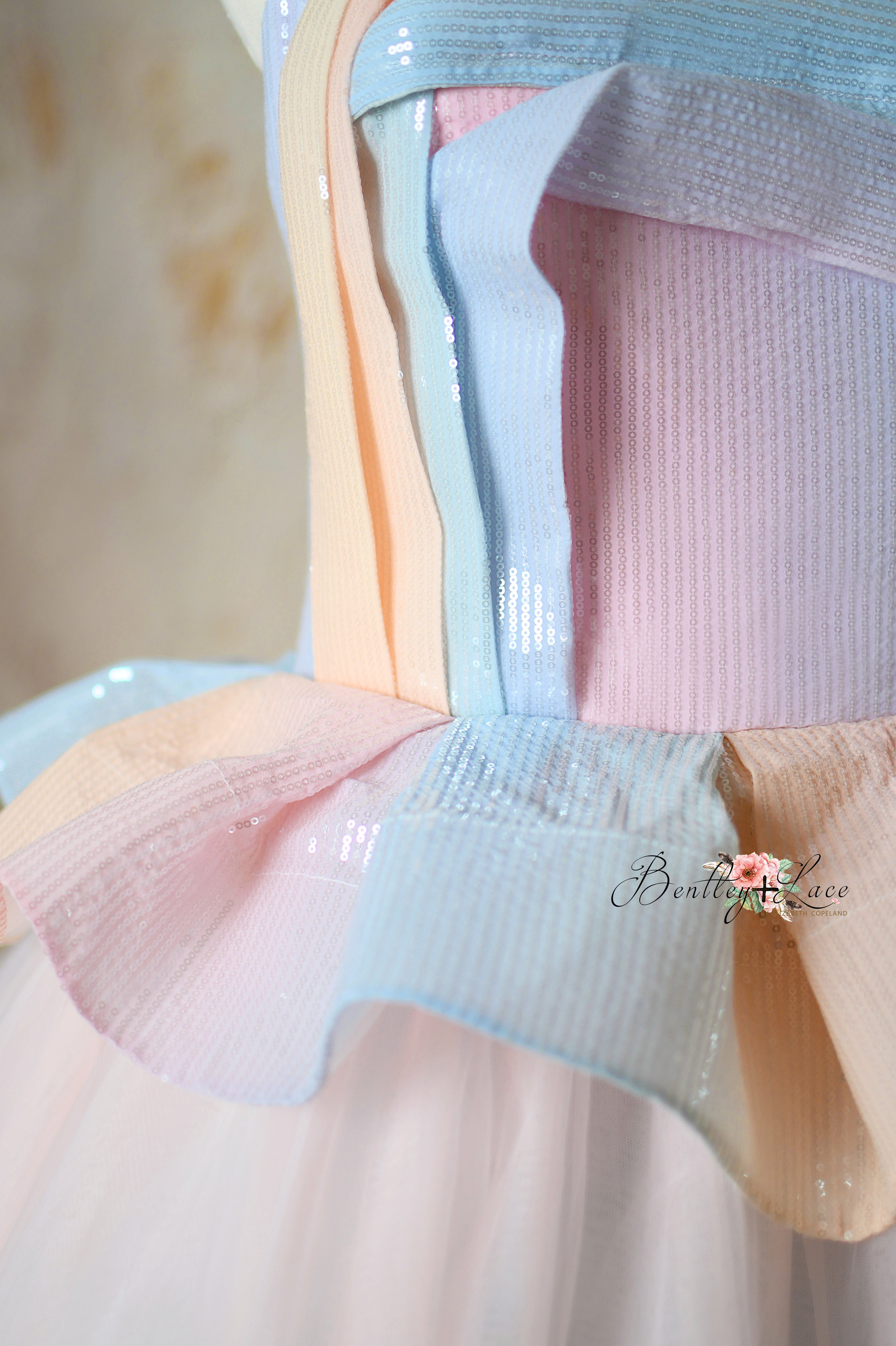 Close-up of the sequin peplum bodice with ruffled pleat detail on the Prism of Dreams gown.
