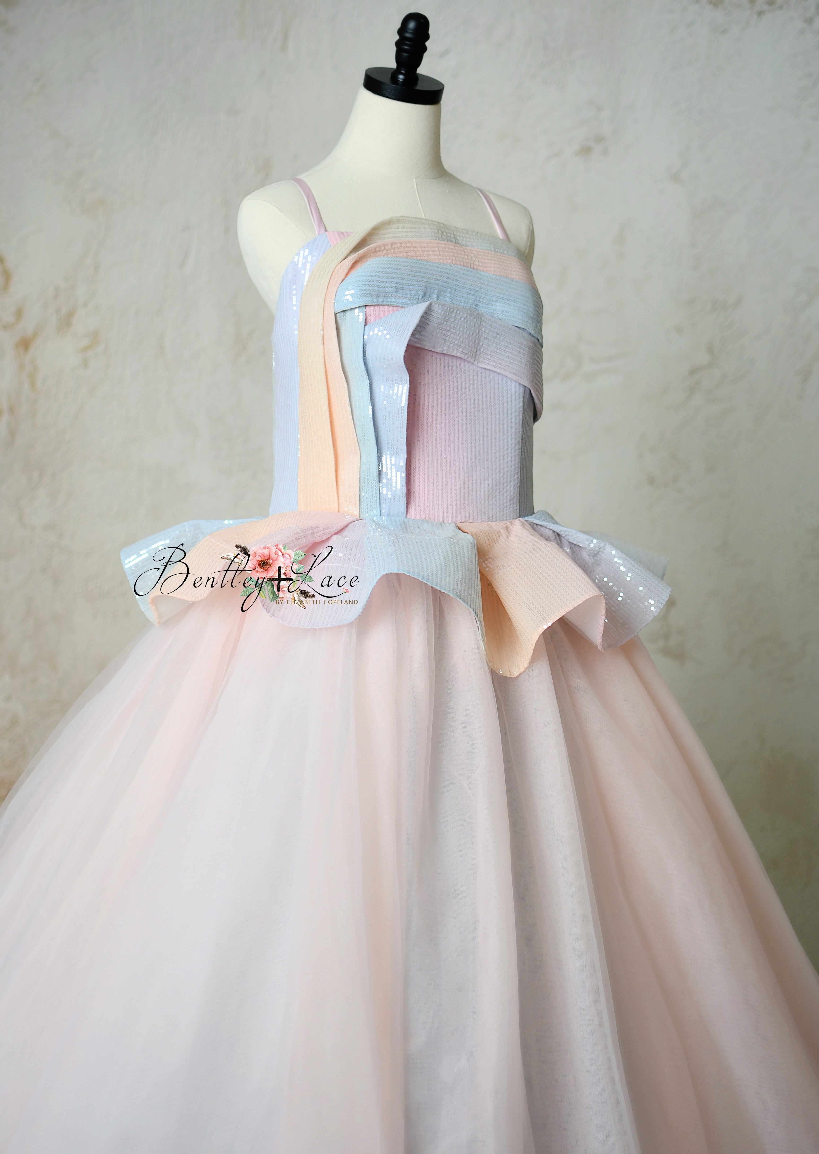 Side view of Prism of Dreams gown featuring a gradient sequin bodice and soft pastel tulle skirt.
