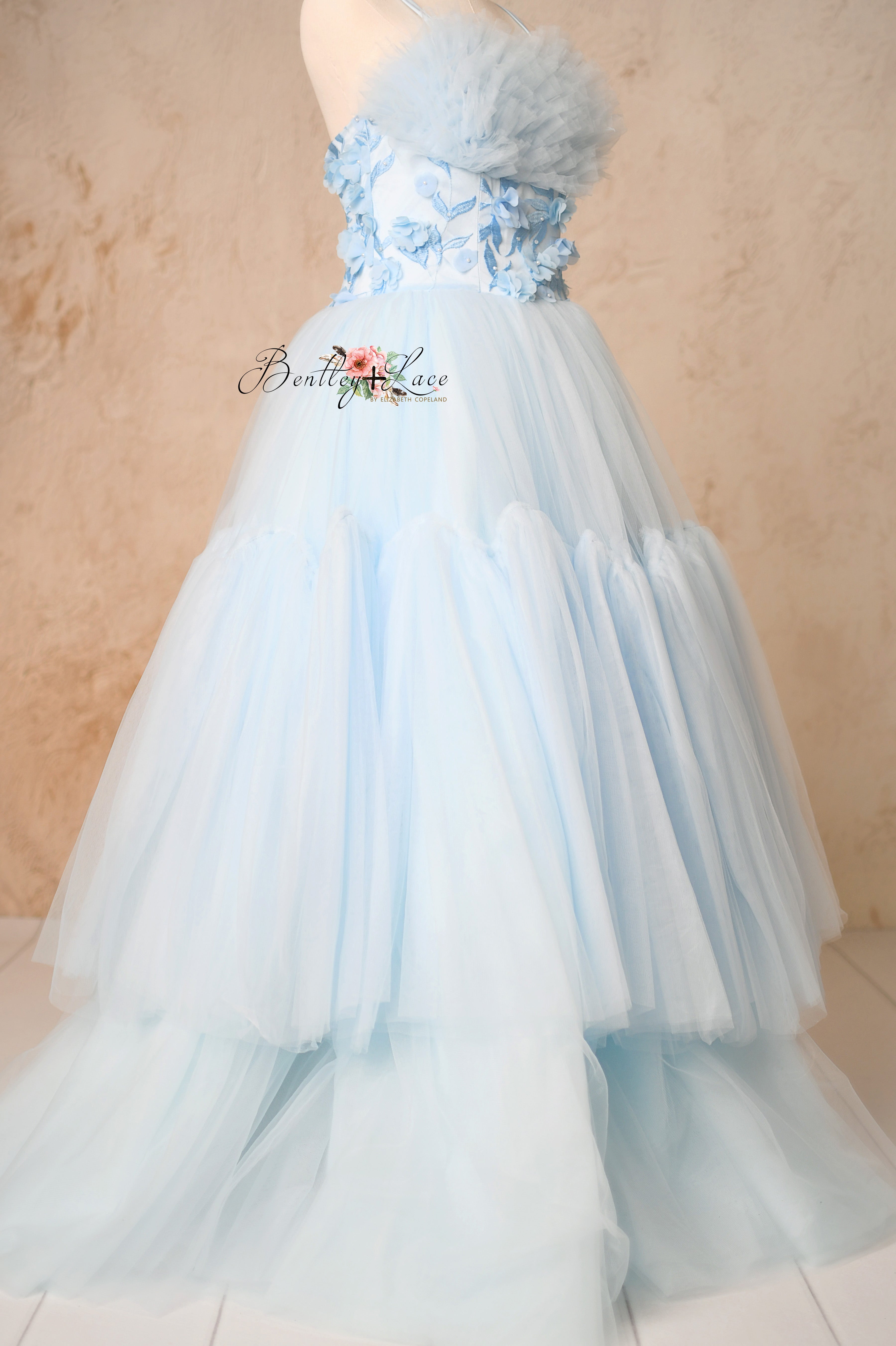 Front view of the Heavenly floor-length gown with flowing tulle layers and an elegant silhouette.
