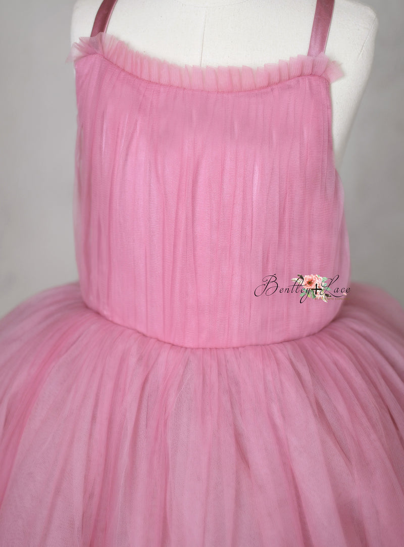 The Bows of Grace floor-length gown featuring intricate hand-sewn bows and satin accents, perfect for special occasions.
