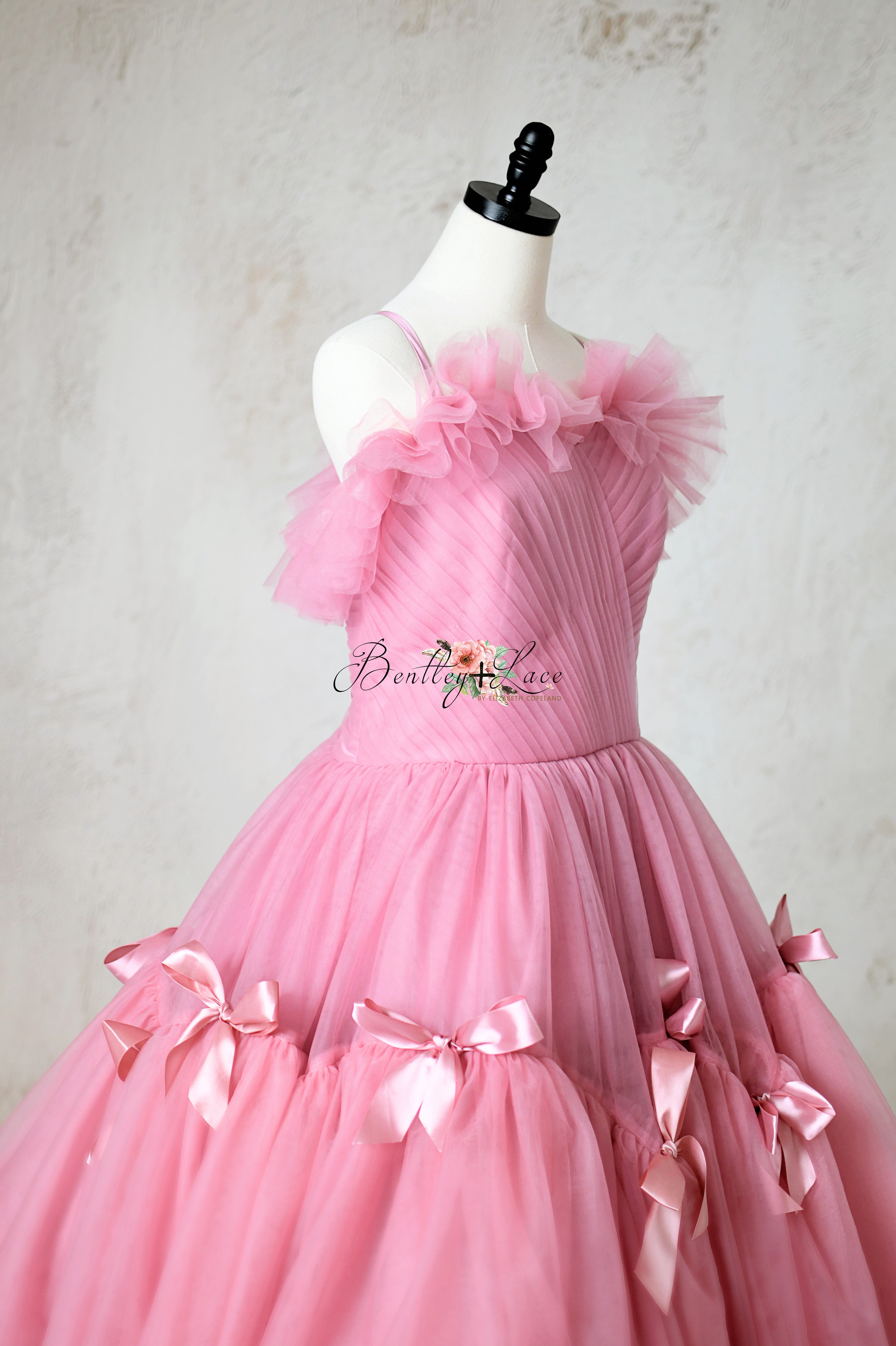 Stunning pink dress with a structured bodice and voluminous tulle skirt.
