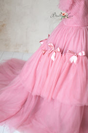 High-fashion pink gown with intricate design details and an ethereal silhouette.
