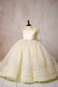 A vision of grace—the Harmony Gown’s soft tulle, intricate floral sequins, and golden shimmer create a picture-perfect look.

