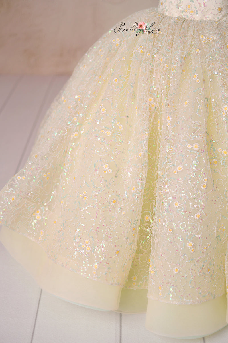 Designed for elegance, the Harmony Gown’s pleated tulle shoulders and sparkling daisy embroidery bring a touch of magic.

