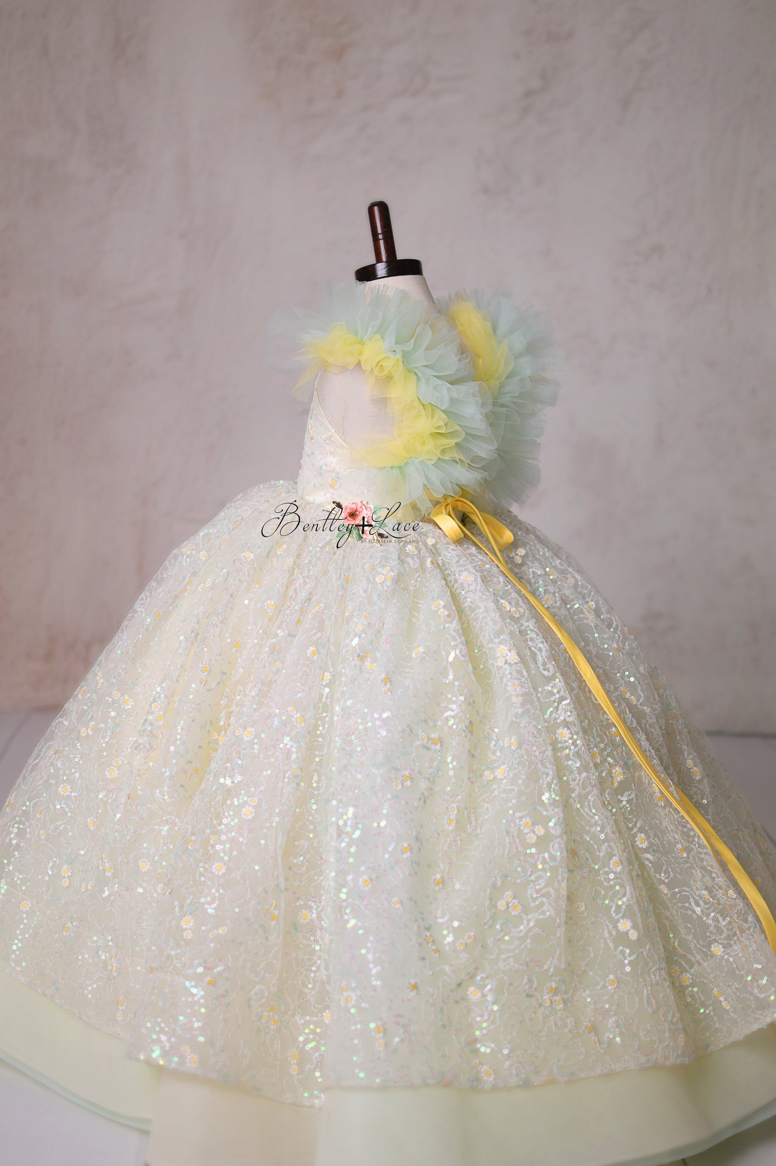 Let your little one shine in the Harmony Gown, a couture masterpiece with delicate lace, ethereal pastels, and a dreamy full skirt.

