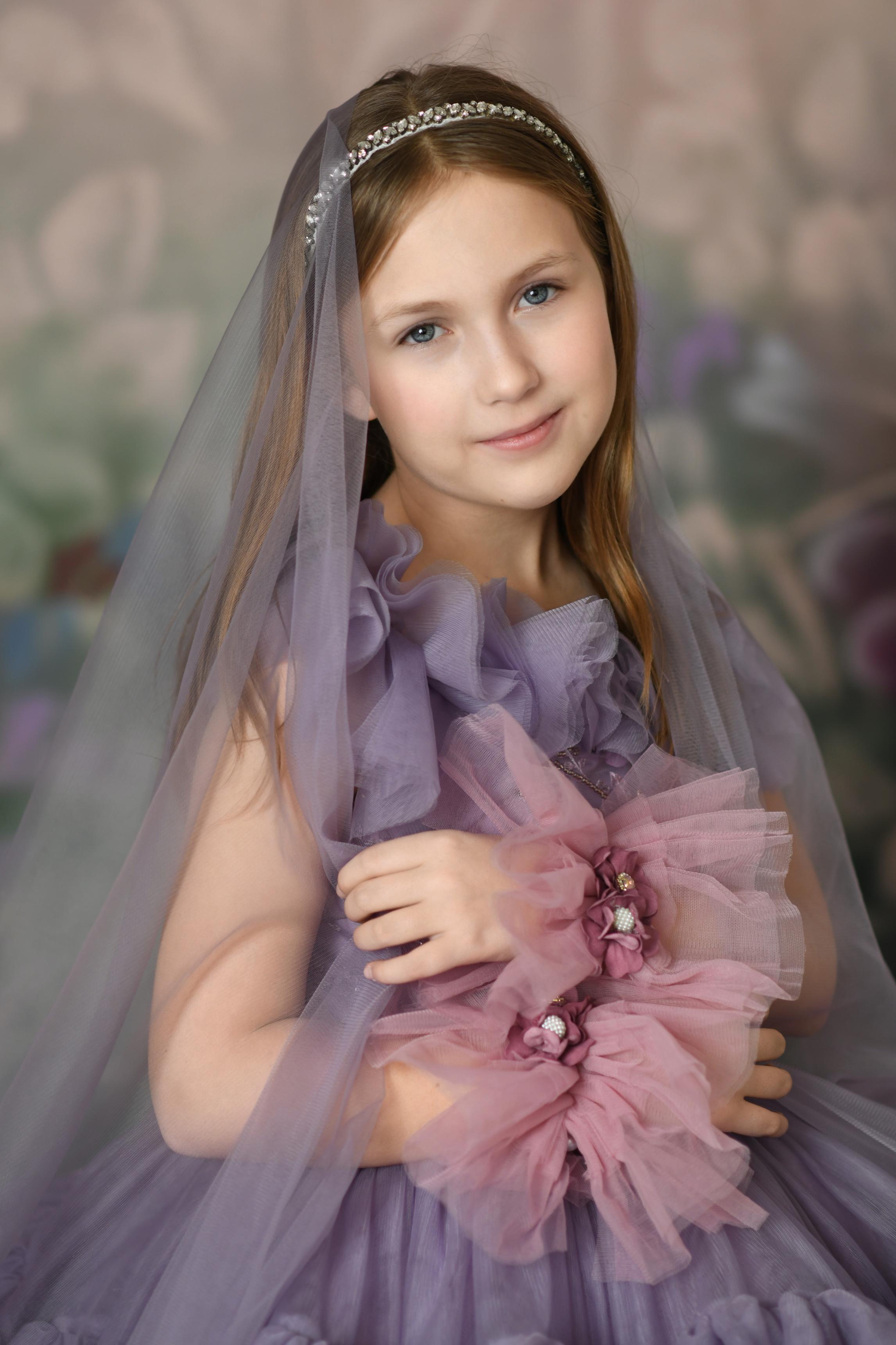 "Stunning purple tulle gown with intricate floral details, perfect for special occasions and photography sessions."
